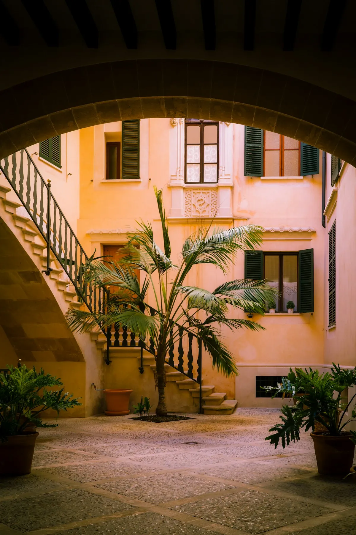 Mediterranean courtyard with staircase and greenery